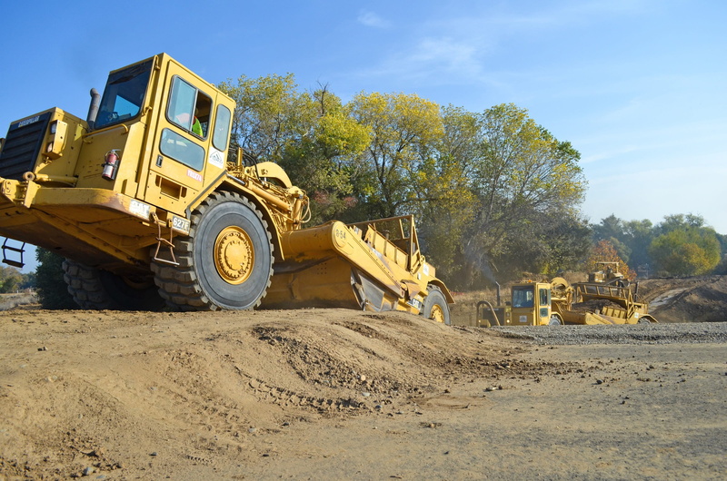 loader, bulldozer, construction equipment, vehicle, power, construction industry, sky, quarry, industrial equipment, trees, dirt road, industry, dig, development
