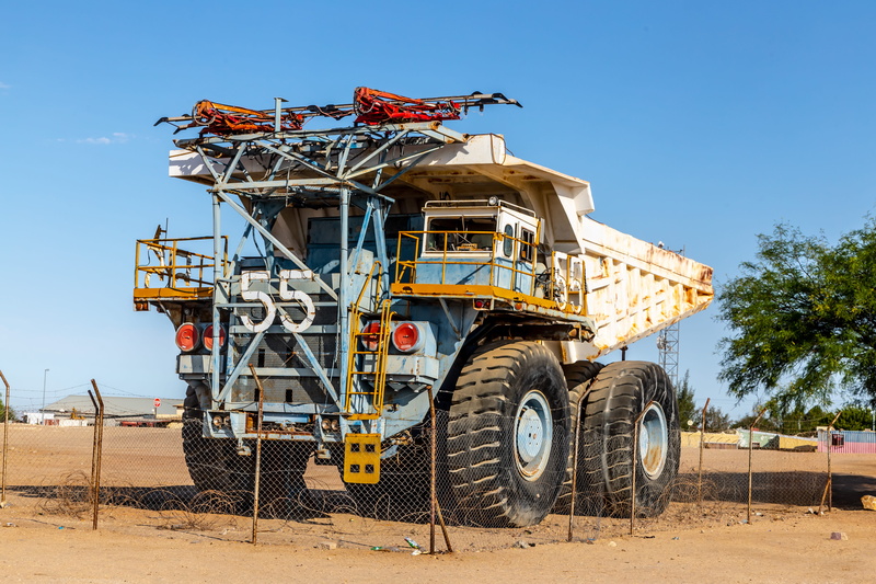 land vehicle, development, architecture, industry, truck, earthmoving equipment × mining × namibia ×, no people, photo, neighborhood, vehicle, urban, coal