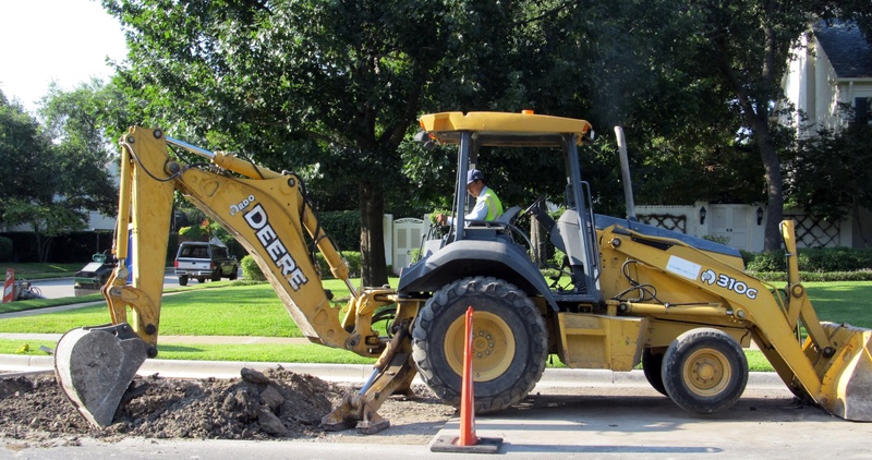front, riding, mode of transportation, plant, sunlight, day, tractor, construction equipment, shovel, machine, construction site, earth, man, street, digger