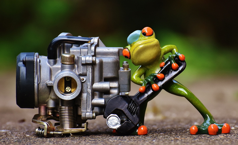 wrench, red, selective focus, metal, tree, still life, toy, male likeness, outdoors, close-up, human representation, gray, engine, photography themes, day