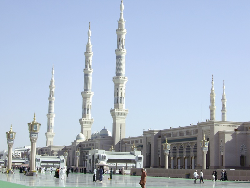 madina, clear sky, architectural column, tradition, place of worship, spire, group of people, building exterior, building, outdoors, spirituality, religion