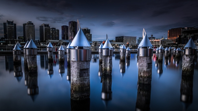 in a row, waterfront, post, sky, victoria, etihad stadium, wood - material, architecture, bay, promenade, built structure, city, building exterior, skyline