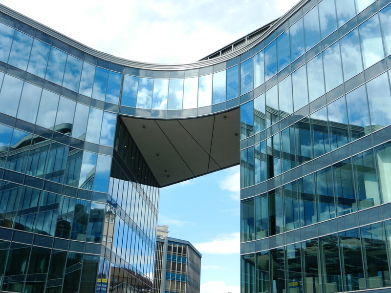 glass - material, buildings, day, person, the skyscraper, office building exterior, modern, office, tower, showing, reflection, office building, facade