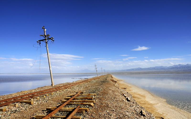 abandoned, electric, scenics - nature, tranquility, no people, blue, white, rust, water, wood - material, connection, post, outdoors, lake, day, cloud - sky