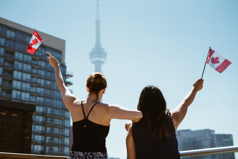 nature, two, facing, celebration, sky, city, canadian, flag, built structure, skyscraper, daytime, office building exterior, party, girls, emotion, architecture
