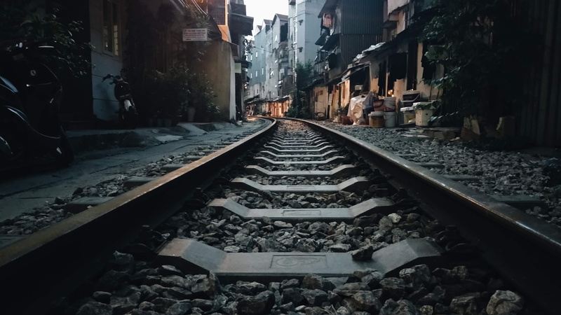 gravel, no people, vanishing point, nature, rubble, building exterior, rail, street, the way forward, solid, metal, mode of transportation, built structure