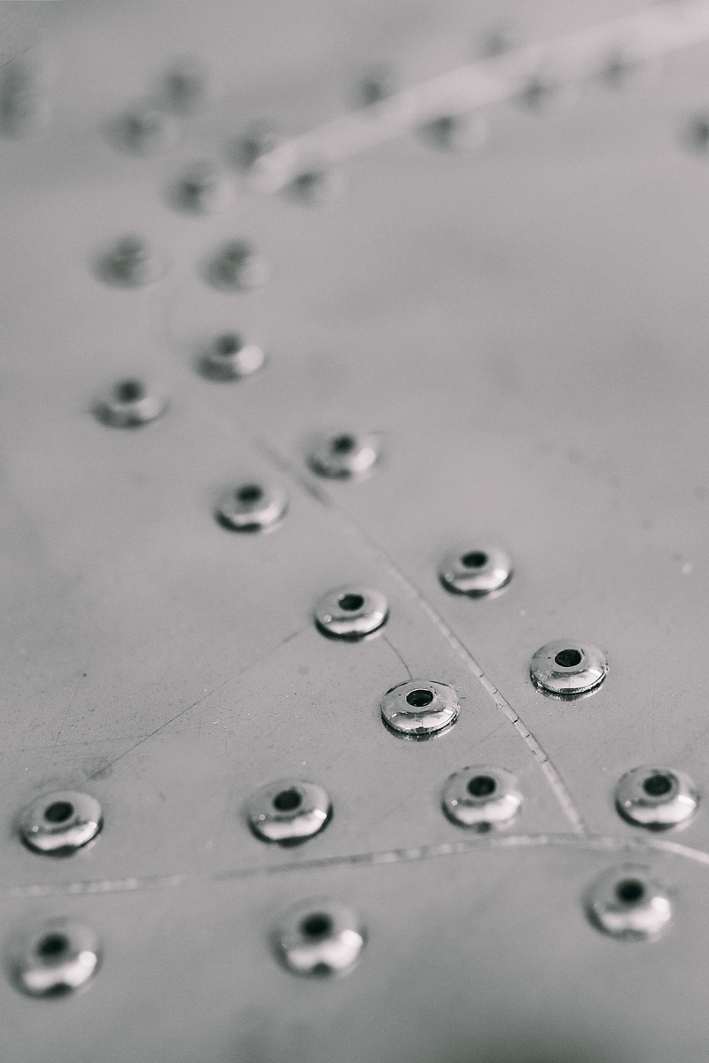 copy space, rivets, 2K, pattern, wet, shiny, silver colored, shape, focus on foreground, selective focus, seamless, metallic, connection, plates, close-up