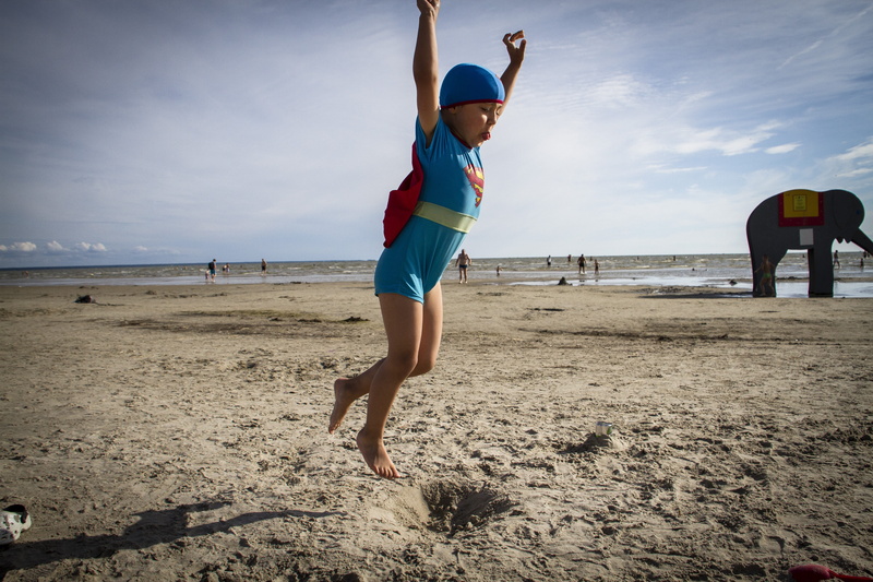 Superman, sky, Jump, one person, beauty in nature, sea, human arm, 5K, sand, outdoors, leisure activity, casual clothing, shorts, Beach, Fun, childhood