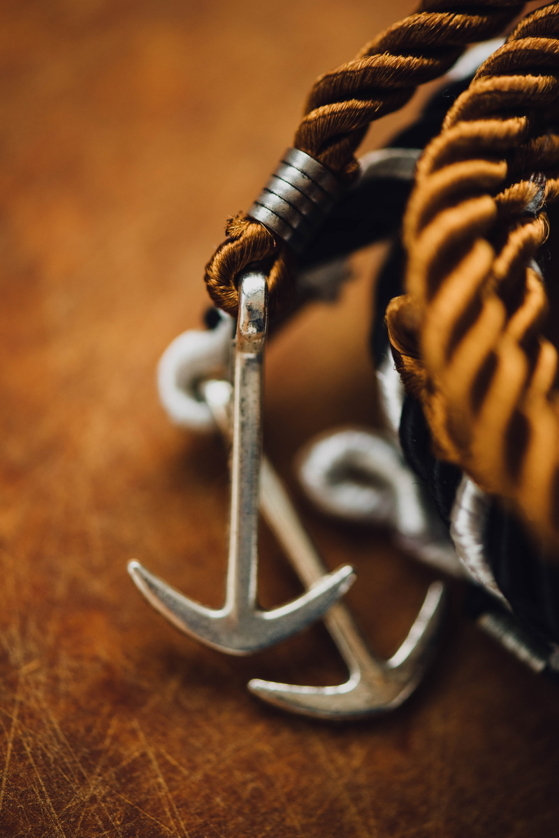 wood - material, wear, string, brown, keychain, steel, communication, selective focus, macro, no people, textile, rope, focus on foreground, high angle view