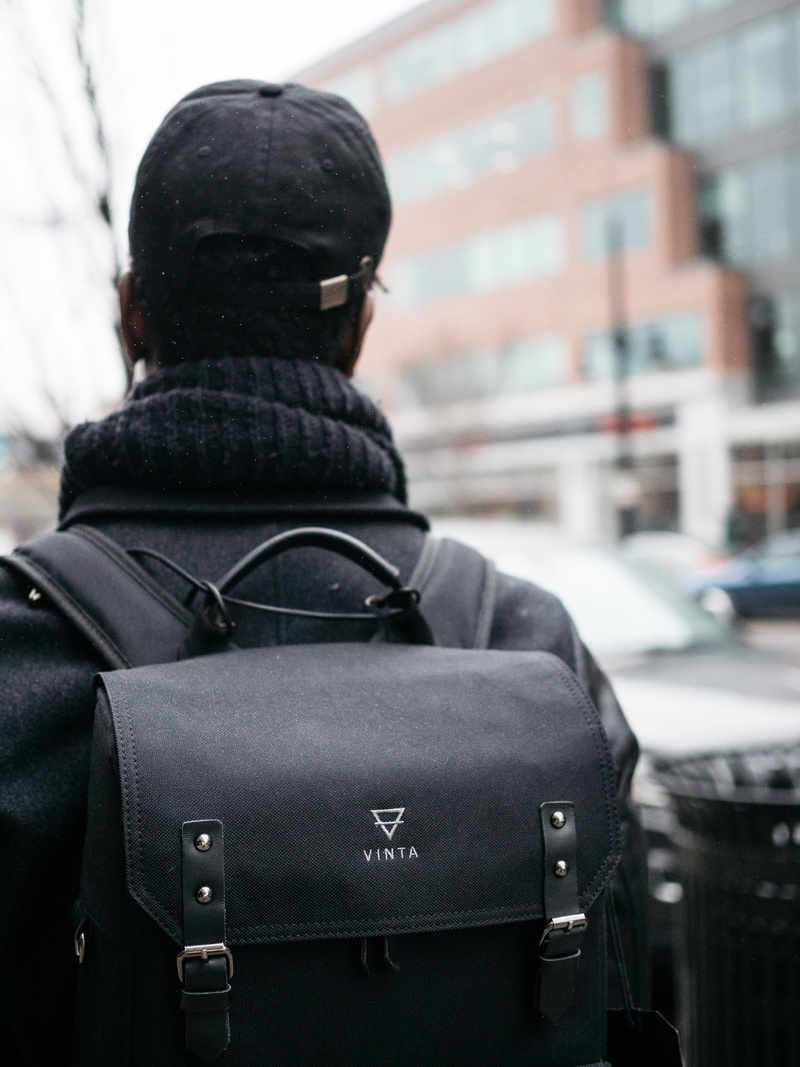 one person, human, urban, architecture, rear view, backpack, photography, work, cloudy, building, 4K, bag, bokeh, hat, warm clothing, top, city, moody