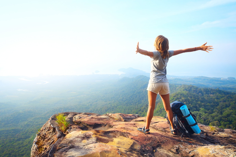 hair, lifestyles, non-urban scene, beauty in nature, young adult, human arm, real people, mountain range, arms raised, nature, sky, mountain, outdoors