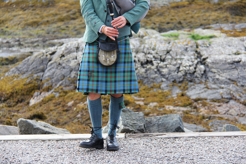 human limb, music, rock - object, portree, performer, uniform, bagpipes, person, playing, carrying, limb, plaid, musical instrument, clothing, human body part