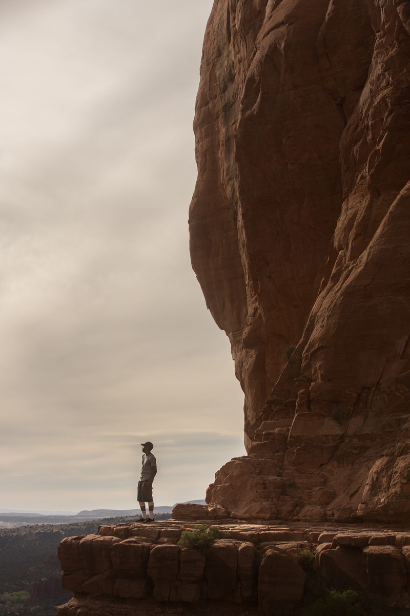rock face, sky, man, formation, wander, standing, rock - object, black man, full length, adventure, horizon, looking out, side view, giant rock, edge, explore