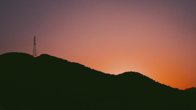 no people, romantic sky, hill, landscape, sunset, tranquil scene, electricity, beauty in nature, technology, tower, mountain range, non-urban scene, outdoors
