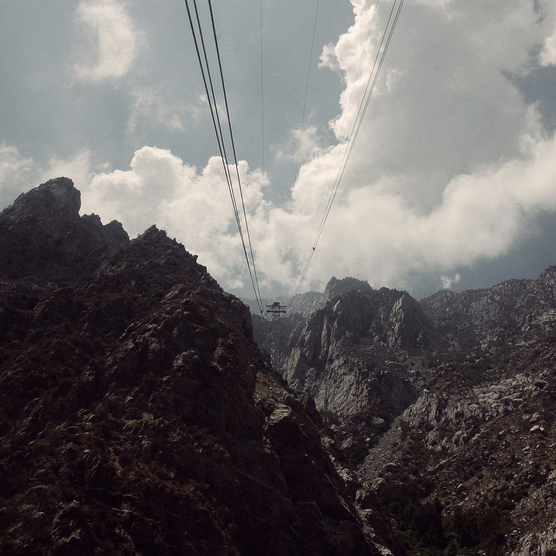 sky, electricity, no people, mountain, valley, mountains, hiking, tranquil scene, day, clouds, natural, power line, rock, peak, summer, mountain peak, low angle view