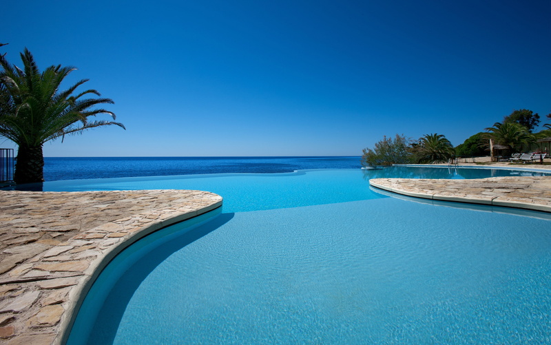 clear sky, sea, tranquil scene, luxury, palm tree, water, horizon over water, beach, tranquility, outdoors, nature, swimming pool, land, tropical climate