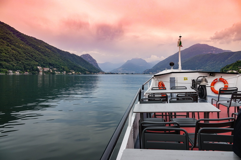 cruise, tranquil scene, lake lugano, mountain range, beauty in nature, passenger craft, lake, pink, mountain peak, nautical vessel, nautical, water, ship