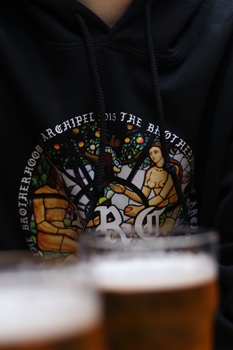 beer - alcohol, t-shirt design, bar, bible, wearing, hand, human hand, beer, human body part, t-shirt, cider, food and drink, midsection, religion, drink