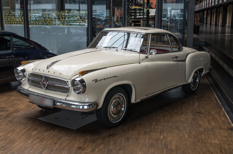 building exterior, stationary, mode of transportation, built structure, luxury, silver colored, land vehicle, vehicle, day, classic, automotive coupe, outdoors