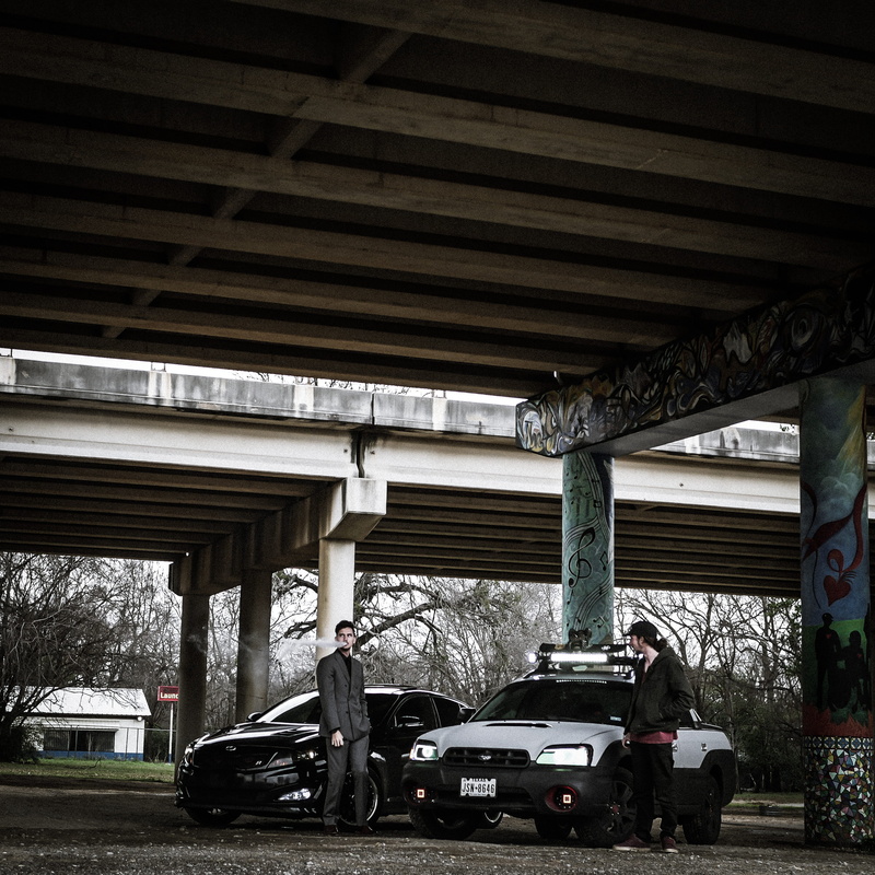 architecture, cars, two, no people, garage, standing, men, 2K, conjunction, man, parking, car, built structure, outdoors, below, urban, ceiling, architectural column