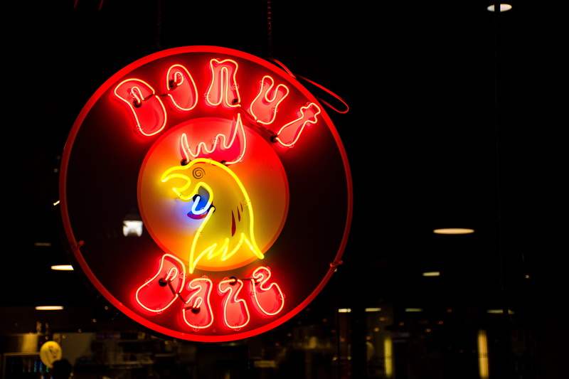 round, black background, colors, drink, donut, round out, light - natural phenomenon, text, night, fast food, signage, commercial sign, road sign, image