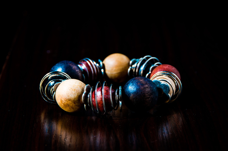 two objects, shining, 8K, dark, round out, round, still life, blue, silver, beads, wood - material, blur, art, bright, jewelry, shapes, colorful, table