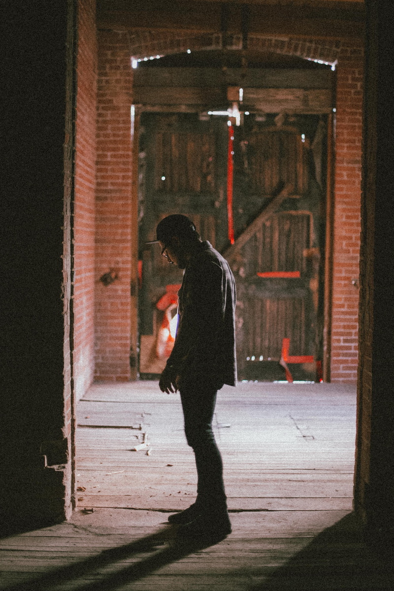 men, night, full length, lonely, sadness, archway, young adult, thinking, teenager, casual clothing, brick, depression - sadness, one person, standing