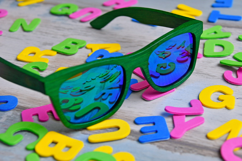 specs, indoors, close-up, large group of objects, green, number, creativity, blue, art and craft, design, text, sunglasses, letter, western script, letters