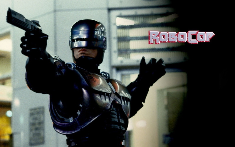 indoors, night, focus on foreground, aggression, gesturing, headwear, text, three quarter length, obscured face, western script, communication, Peter Weller