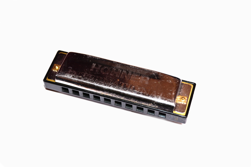 harmonica, copy space, man made object, gold colored, street art, piece of music, steel, white, communication, white background, music, entertainment, stainless