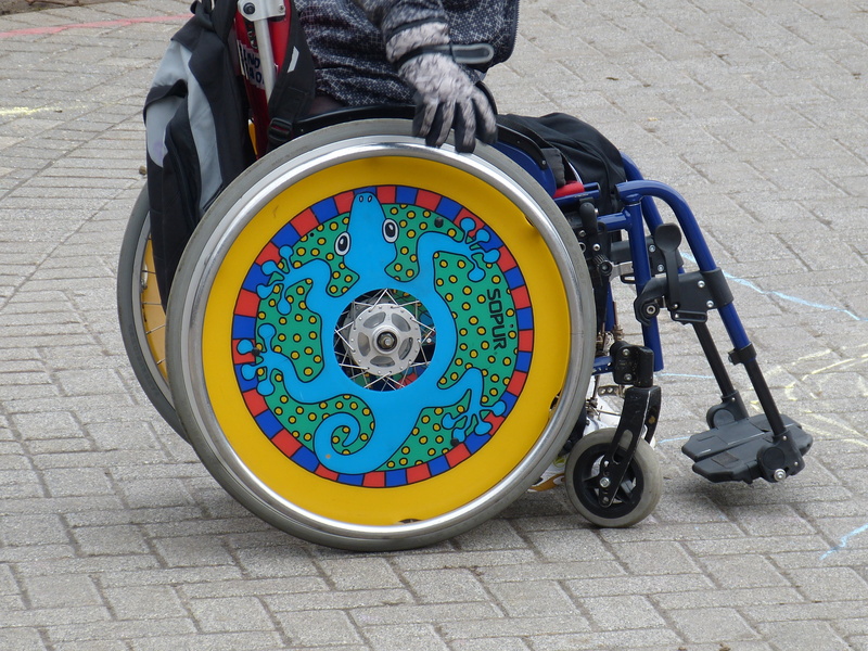 mobility, geometric shape, low section, disability, disabled, real people, propelled, wheel, one person, mode of transportation, paving stone, high angle view