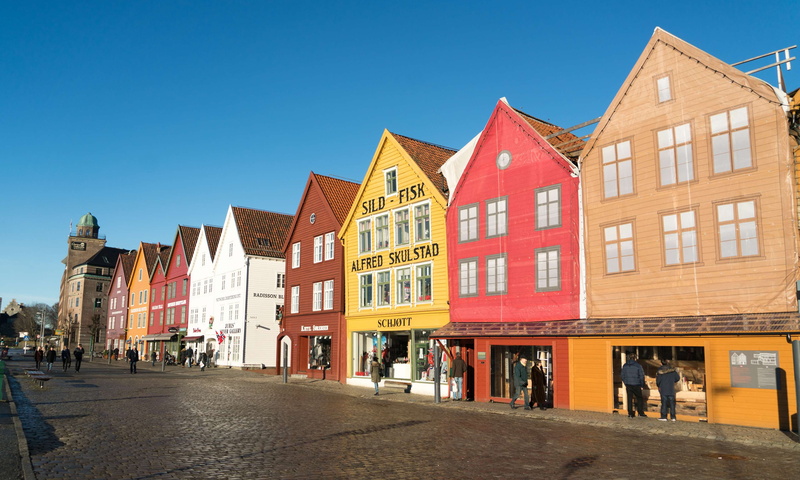 in a row, day, blue, cafe, clear sky, colorful, architecture, incidental people, row house, landscape, building, bergen, residential district, window, built structure