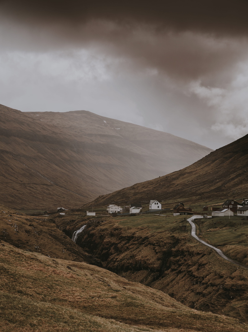 tranquil scene, highland, hillside, stream, wilderness, tranquility, beauty in nature, no people, near, day, cloudy, saksun, barren, grass, road, houses