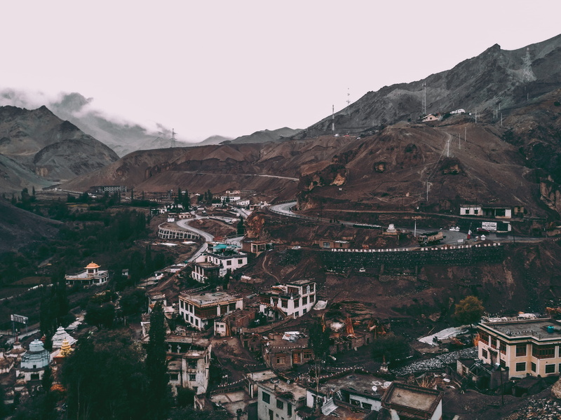 mountain, no people, outdoors, beauty in nature, built structure, town, sight, village, roofs, day, townscape, grey, roads, cityscape, scenic, sky, houses