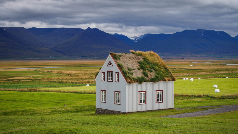 sod house, meadow, roof, soddy, mountain range, rural scene, cottage, pasture, sky, turfhouse, grassland, cloud, built structure, green color, nature, architecture