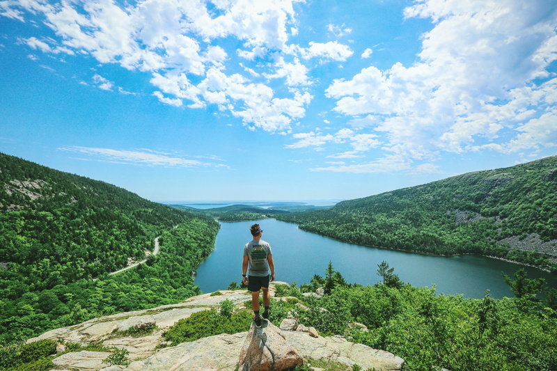 one person, casual clothing, non-urban scene, mount desert, water, tranquil scene, idyllic, person, mountain, man, woodland, tranquility, tree, outdoors