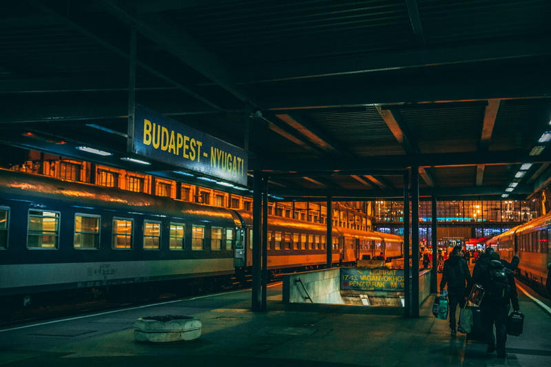 transportation, train, holding, standing, travel, built structure, text, bags, walking, station, people, building exterior, city, women, mode of transportation