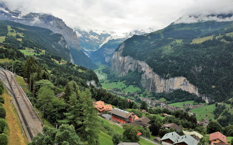green color, landscape, idyllic, architecture, building exterior, town, daylight, tranquility, road, day, scenery, outdoors, hill, lauterbrunnen, mountain range