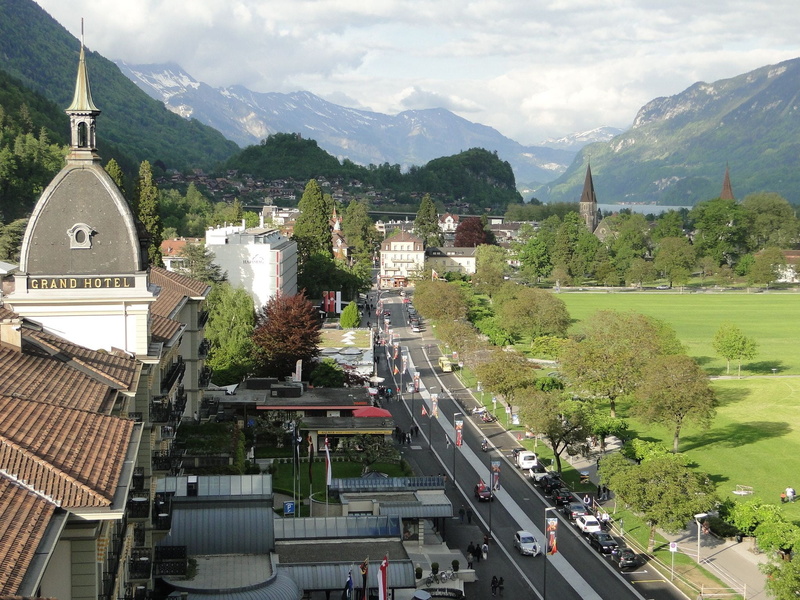 city, interlaken, street, incidental people, mountains, road, plant, 1080P, car, switzerland, built structure, sky, mountain range, landscape, europe