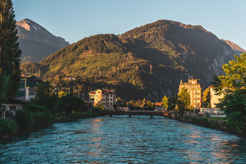 day, building exterior, trees, mountain range, switzerland, nature, outdoors, tree, built structure, water, golden hour, sunrise, plant, scenics - nature