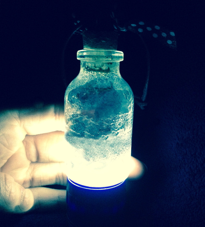 blue, close-up, gespentisch, table, one person, genie, finger, person, transparent, bottle, single object, dark, container, spooky, laboratory, atmosphere