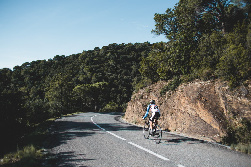 country road, motion, one person, road, sky, lifestyles, bend, outdoor, view, valley, curvy, summer, cycling, travel, riding, getaway, countryside, plant