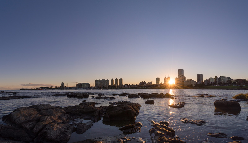 cityscape, montevideo, rock - object, copy space, sunset, puerto de buceo, building exterior, sea, skyscraper, sun, no people, city, nature, solid, urban skyline