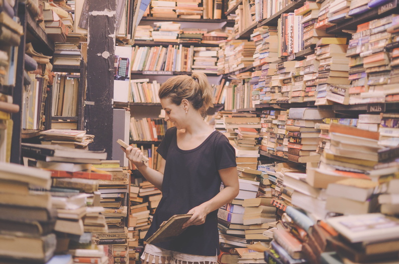 stack, reading, women, hairstyle, 4K, publication, holding, young women, casual clothing, uruguay, standing, shelf, studying, indoors, old books, young adult