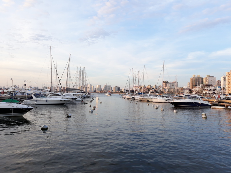 sailboat, waterfront, building exterior, water, pole, day, nautical vessel, architecture, sea, harbor, port, marina, city, moored, mode of transportation