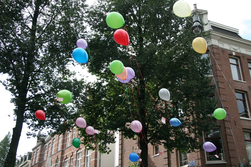 day, street scene, hanging, nature, built structure, tree, multi colored, balloon, decoration, balloons, building exterior, amsterdam, plant, inflatable