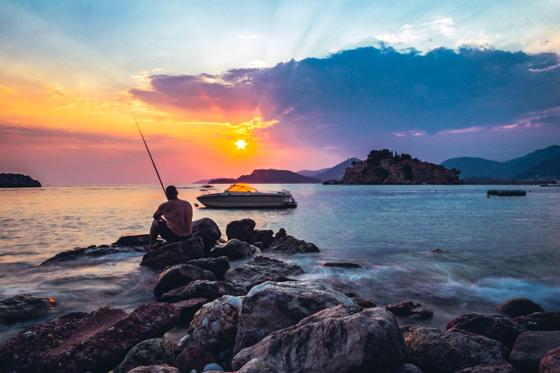 nature, fisherman, rock - object, sveti stefan beach, tranquil scene, rock, looking at view, sky, water, lifestyles, tranquility, leisure activity, horizon over water