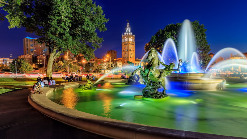 motion, illuminated, city, amusement park, blurred motion, plant, architecture, travel destinations, speed, tree, sky, fountain, horse, sculpture, building exterior
