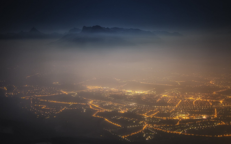 fog, building exterior, landscape, aerial view, no people, Salzburg, mountains, mountain range, Austria, cloud - sky, lights, cityscape, mist, yellow, architecture