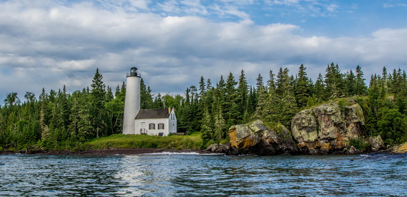 sky, day, tree, lighthouse, architecture, no people, built structure, cloud - sky, pine tree, rock harbor lighthouse, nature, building, plant, outdoors